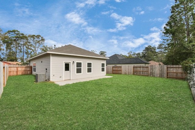 rear view of house featuring a yard