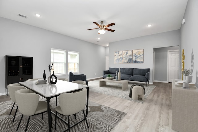 dining room with ceiling fan and light hardwood / wood-style flooring