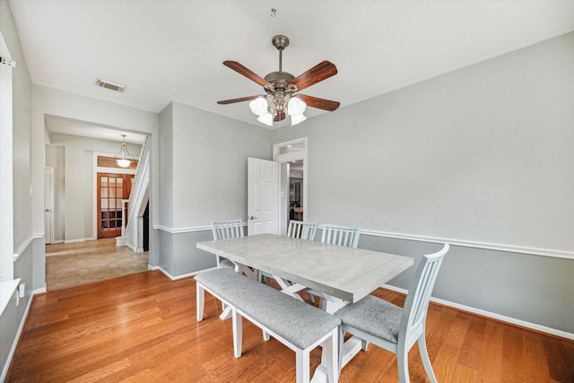 dining space with ceiling fan and light hardwood / wood-style floors