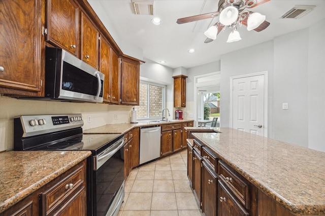 kitchen featuring ceiling fan, light tile patterned flooring, sink, and stainless steel appliances