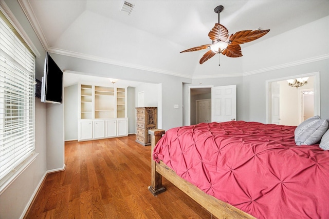 bedroom with vaulted ceiling, wood-type flooring, ceiling fan with notable chandelier, and ornamental molding