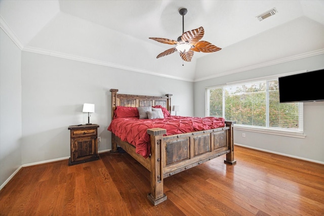 bedroom featuring a raised ceiling, crown molding, vaulted ceiling, ceiling fan, and wood-type flooring