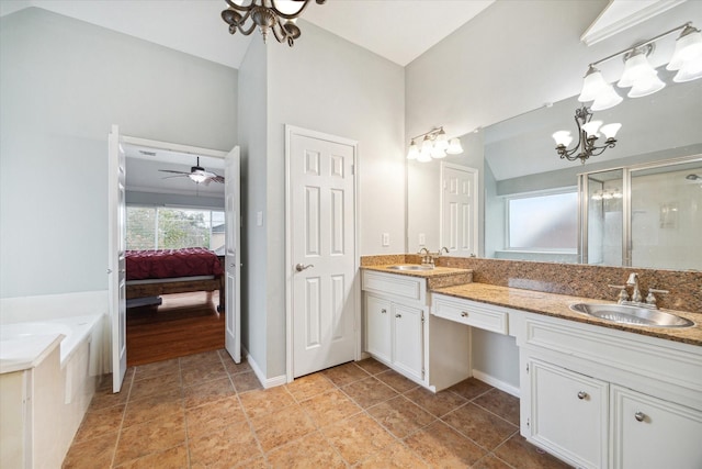 bathroom featuring ceiling fan, separate shower and tub, vanity, and vaulted ceiling