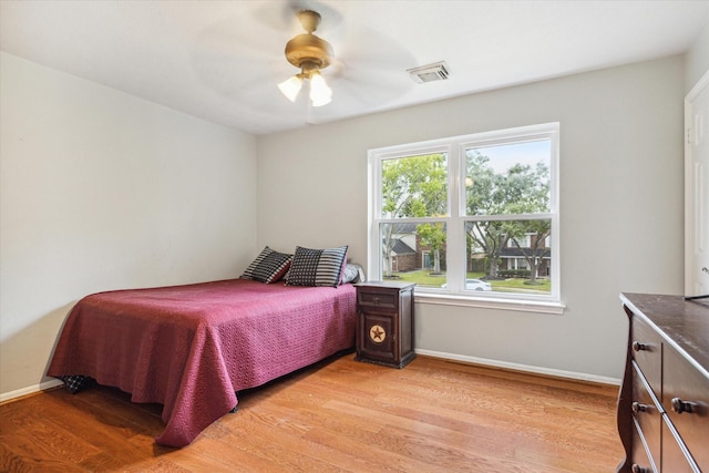 bedroom with light hardwood / wood-style flooring and ceiling fan