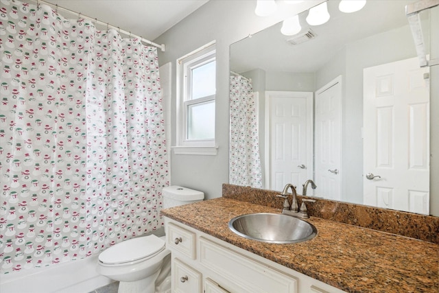 full bathroom with vanity, toilet, and shower / bath combo