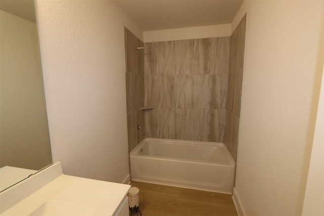 full bath with vanity, wood finished floors, and washtub / shower combination