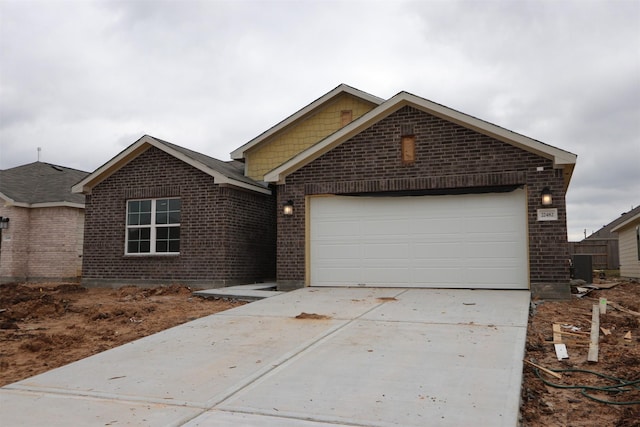 ranch-style house with an attached garage, brick siding, and driveway