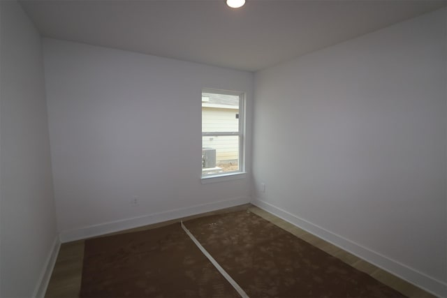 unfurnished room with wood finished floors and baseboards