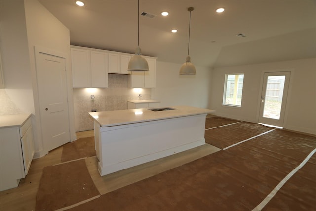 kitchen with visible vents, recessed lighting, vaulted ceiling, white cabinets, and light wood-type flooring