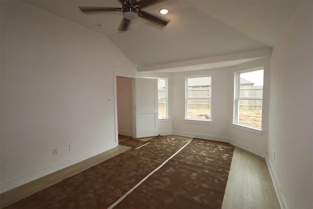 empty room with baseboards, a ceiling fan, lofted ceiling, and wood finished floors