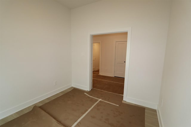 unfurnished room with wood finished floors and baseboards