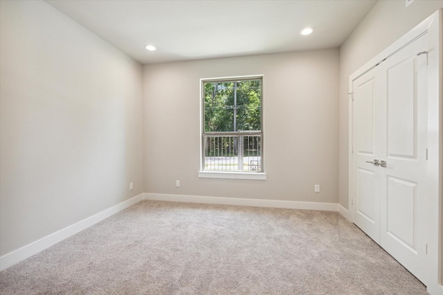 unfurnished bedroom with light carpet