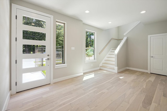 foyer entrance with light hardwood / wood-style flooring and plenty of natural light