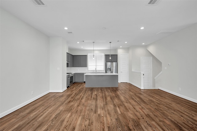 unfurnished living room featuring dark hardwood / wood-style floors and sink