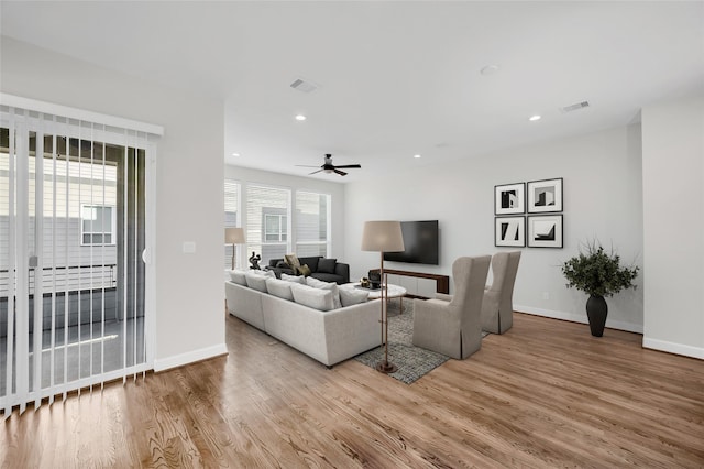 living room featuring ceiling fan and light hardwood / wood-style flooring