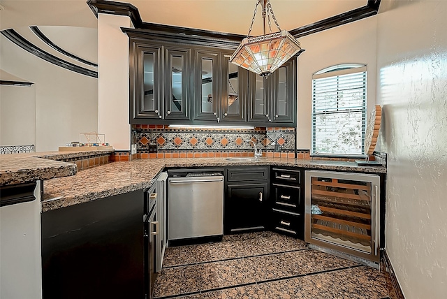 kitchen with sink, beverage cooler, tasteful backsplash, decorative light fixtures, and ornamental molding