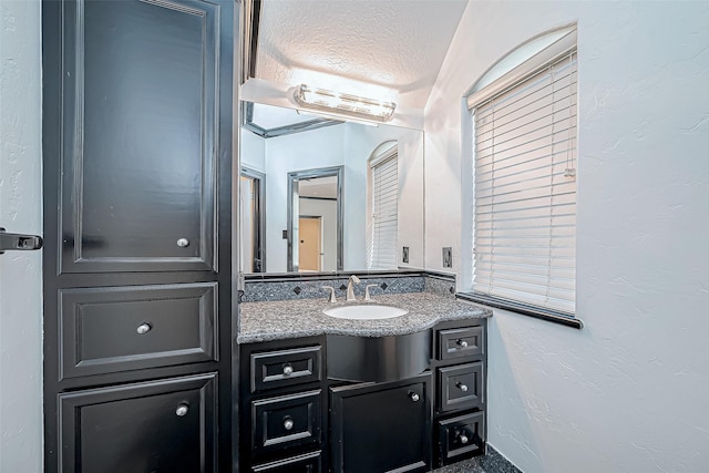 bathroom featuring vanity and a textured ceiling