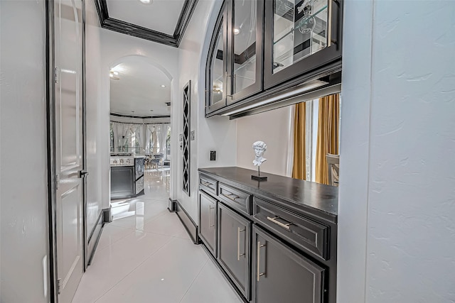 kitchen with light tile patterned floors and ornamental molding