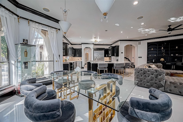 living room with ceiling fan, light tile patterned floors, and ornamental molding