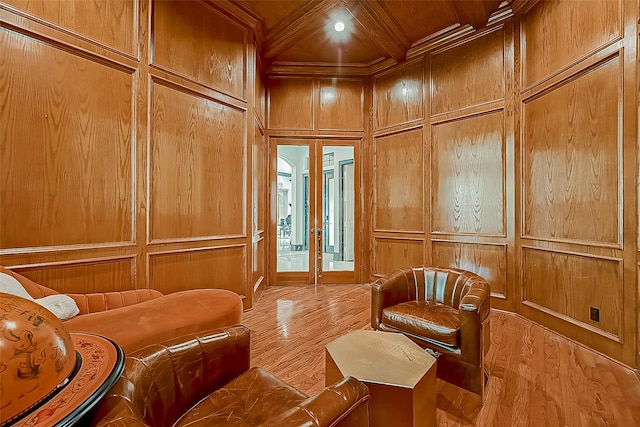 living area with wooden ceiling, french doors, wooden walls, and light hardwood / wood-style flooring