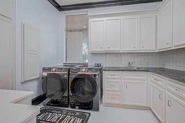 laundry area with washer and clothes dryer, cabinets, crown molding, sink, and light tile patterned floors