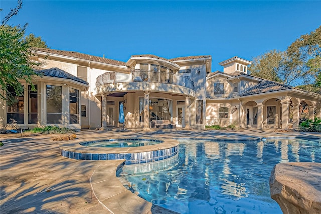 view of swimming pool with an in ground hot tub