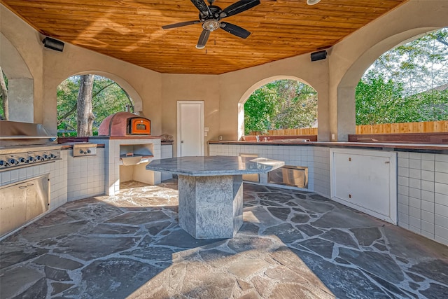 view of patio / terrace featuring ceiling fan and exterior kitchen