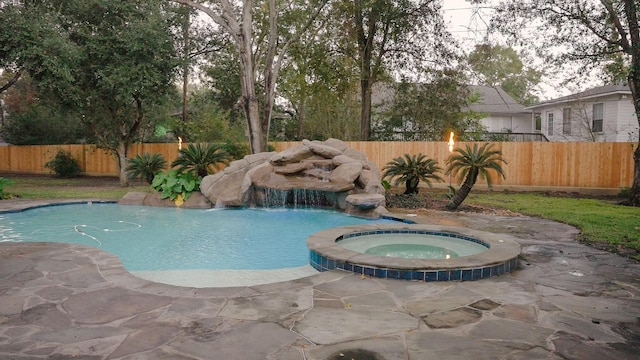 view of swimming pool with an in ground hot tub