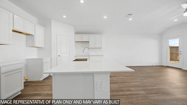 kitchen featuring sink, hardwood / wood-style flooring, white cabinetry, lofted ceiling, and an island with sink