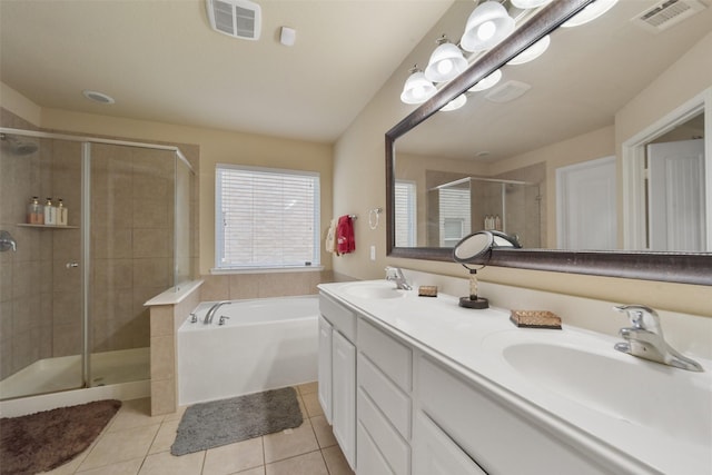 bathroom with tile patterned floors, vanity, and shower with separate bathtub