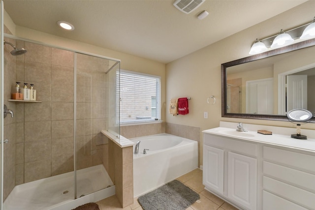 bathroom with tile patterned floors, separate shower and tub, and vanity