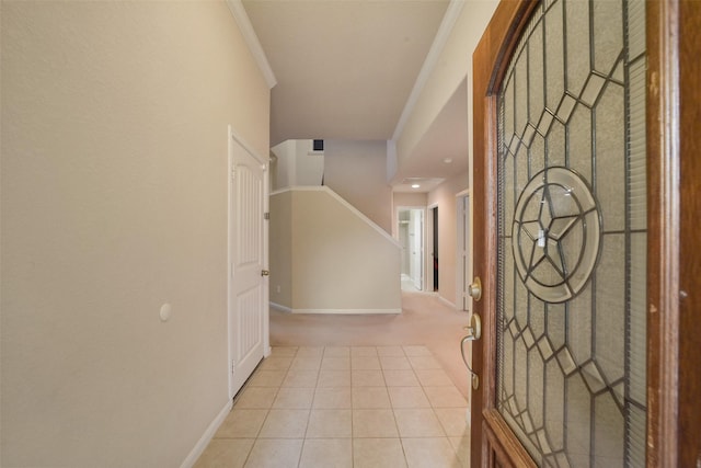 tiled entryway featuring ornamental molding