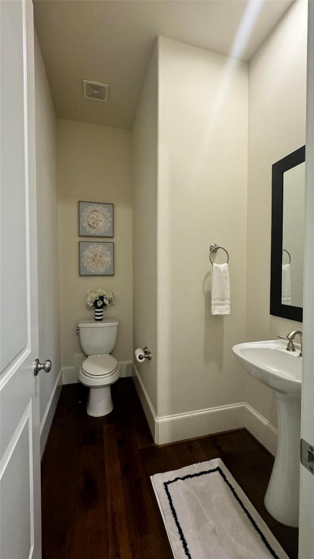 bathroom featuring toilet and hardwood / wood-style flooring