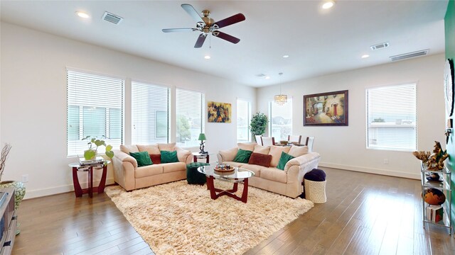 living room featuring hardwood / wood-style floors, ceiling fan, and a wealth of natural light