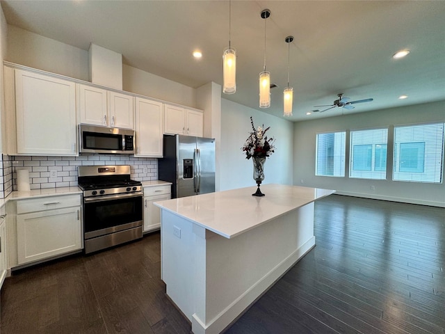 kitchen featuring appliances with stainless steel finishes, a kitchen island, and white cabinets