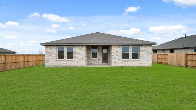 back of property featuring a lawn and a patio area