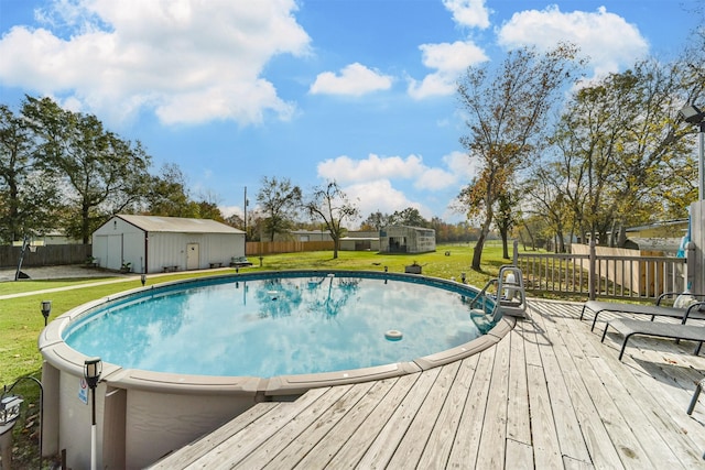 view of pool featuring a lawn, an outbuilding, and a deck