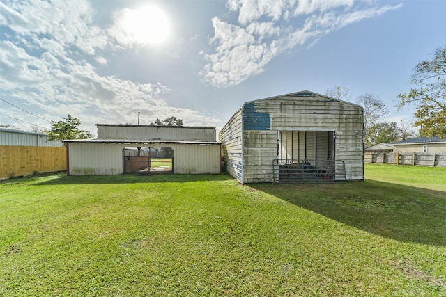 view of outbuilding featuring a lawn