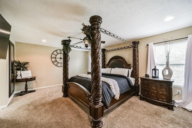 bedroom featuring a textured ceiling and light colored carpet