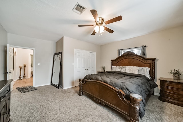 bedroom featuring a closet, light colored carpet, and ceiling fan