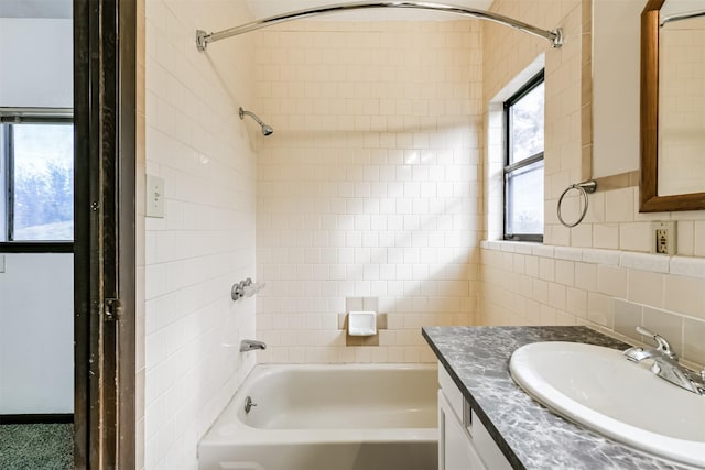 bathroom with tasteful backsplash, tub / shower combination, and vanity