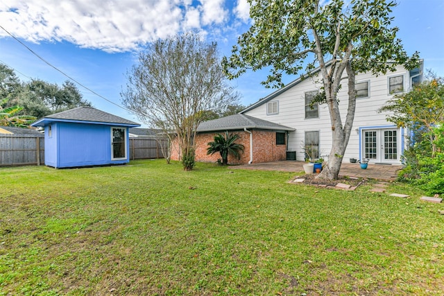 view of yard featuring an outbuilding, a fenced backyard, a patio, and cooling unit