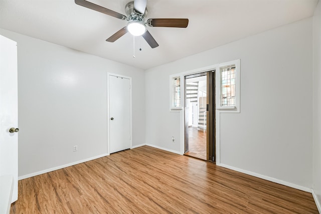 unfurnished bedroom featuring ceiling fan, baseboards, and wood finished floors