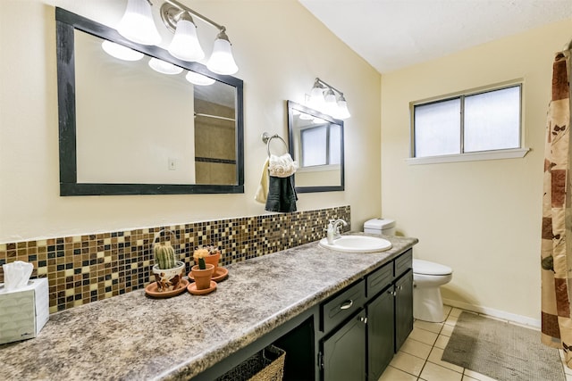 full bathroom with tile patterned flooring, toilet, vanity, baseboards, and backsplash