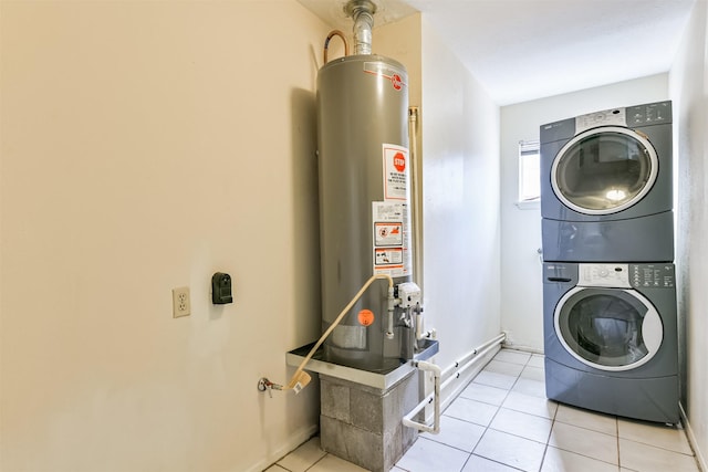 laundry room with light tile patterned floors, stacked washer and dryer, water heater, laundry area, and baseboards