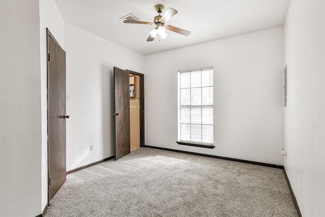 unfurnished bedroom featuring light carpet, ceiling fan, visible vents, and baseboards