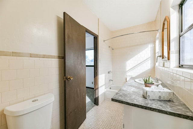 full bathroom featuring tile walls, toilet, tub / shower combination, vanity, and tile patterned floors