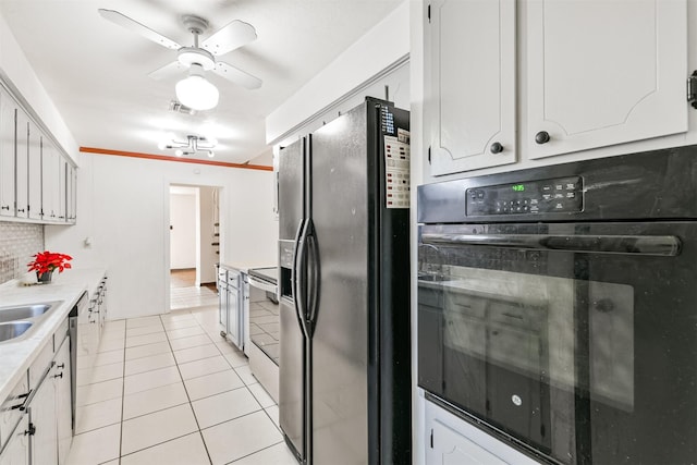 kitchen with white cabinets, black appliances, light tile patterned floors, and light countertops