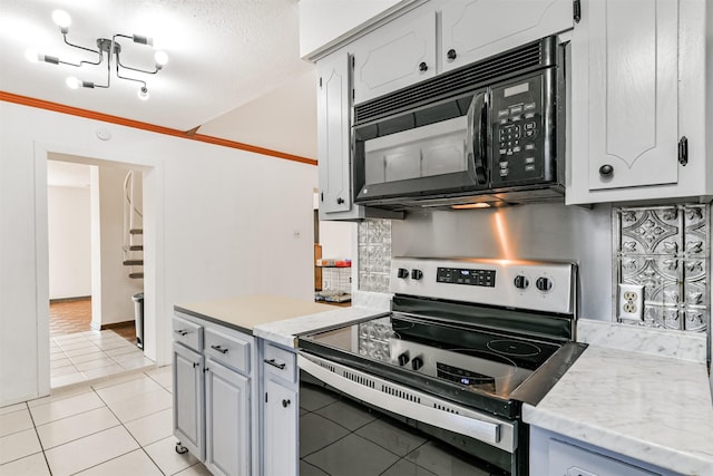 kitchen with stainless steel electric range oven, light tile patterned floors, tasteful backsplash, ornamental molding, and black microwave