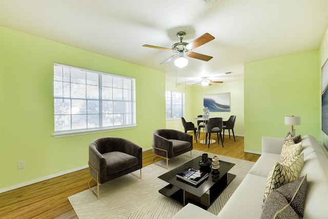 living area featuring light wood-type flooring and baseboards